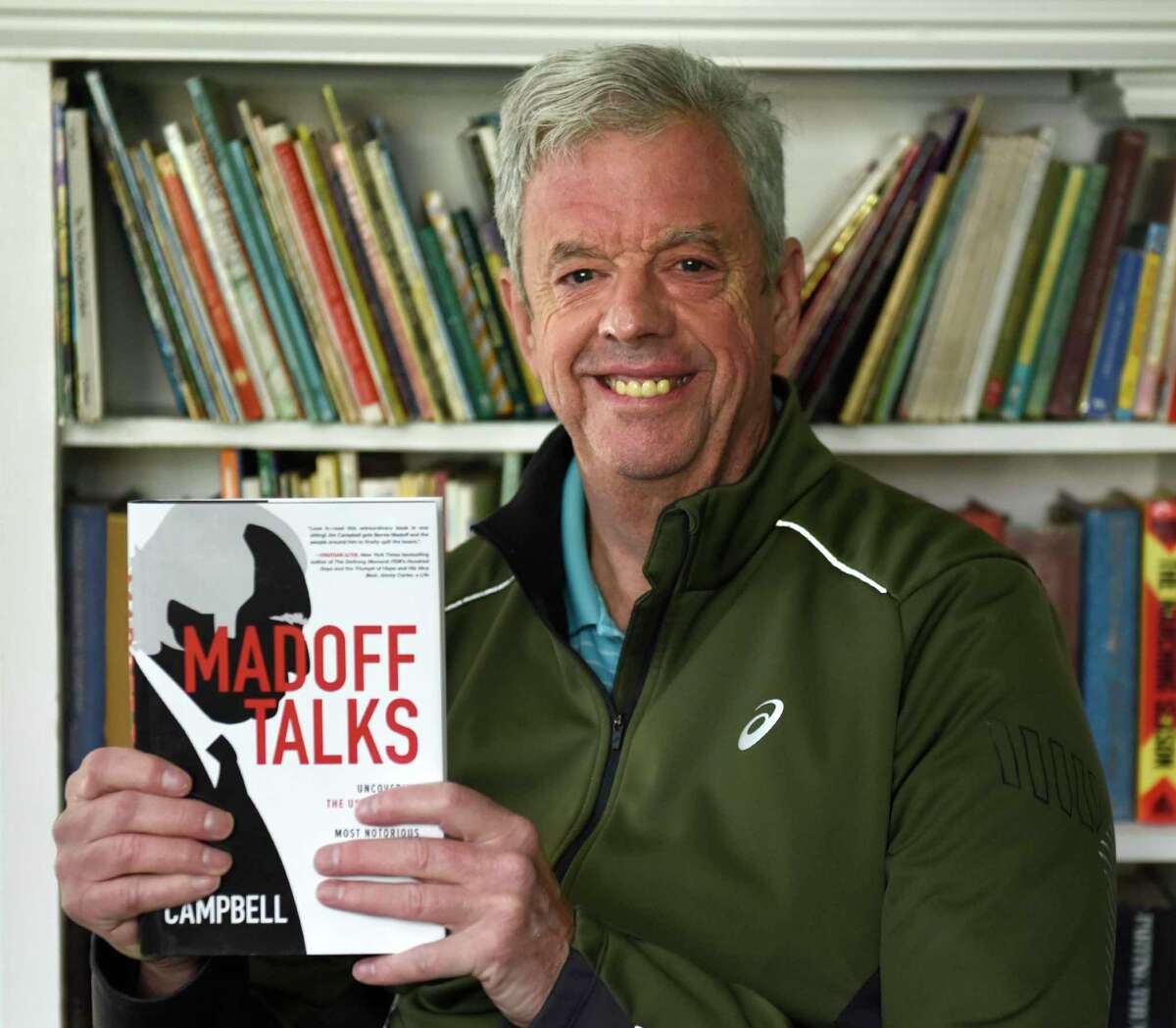 WGCH host Jim Campbell holds his new book "Madoff Talks" at his home in Old Greenwich, Conn. Thursday, April 22, 2021. Campbell has written a comprehensive new book about notorious Ponzi scheme fraudster Bernie Madoff.