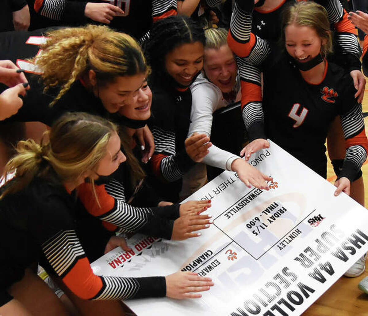 The Edwardsville girls volleyball team celebrates after winning the Class 4A DeKalb Super-Sectional on Friday to punch its ticket to the state tournament.