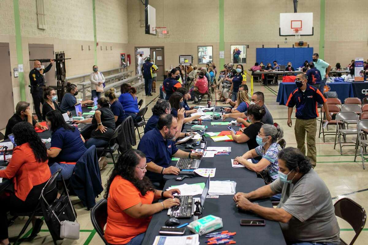 CPS Energy Advisors help customers during a CPS Energy utility assistance fair held at the Normoyle Community Center in San Antonio, Texas, on Nov. 2, 2021. CPS has been holding fairs in districts across San Antonio in partnership with Bexar County, San Antonio Water System, the City of San Antonio, and other agencies to help people in need of help with utilities.
