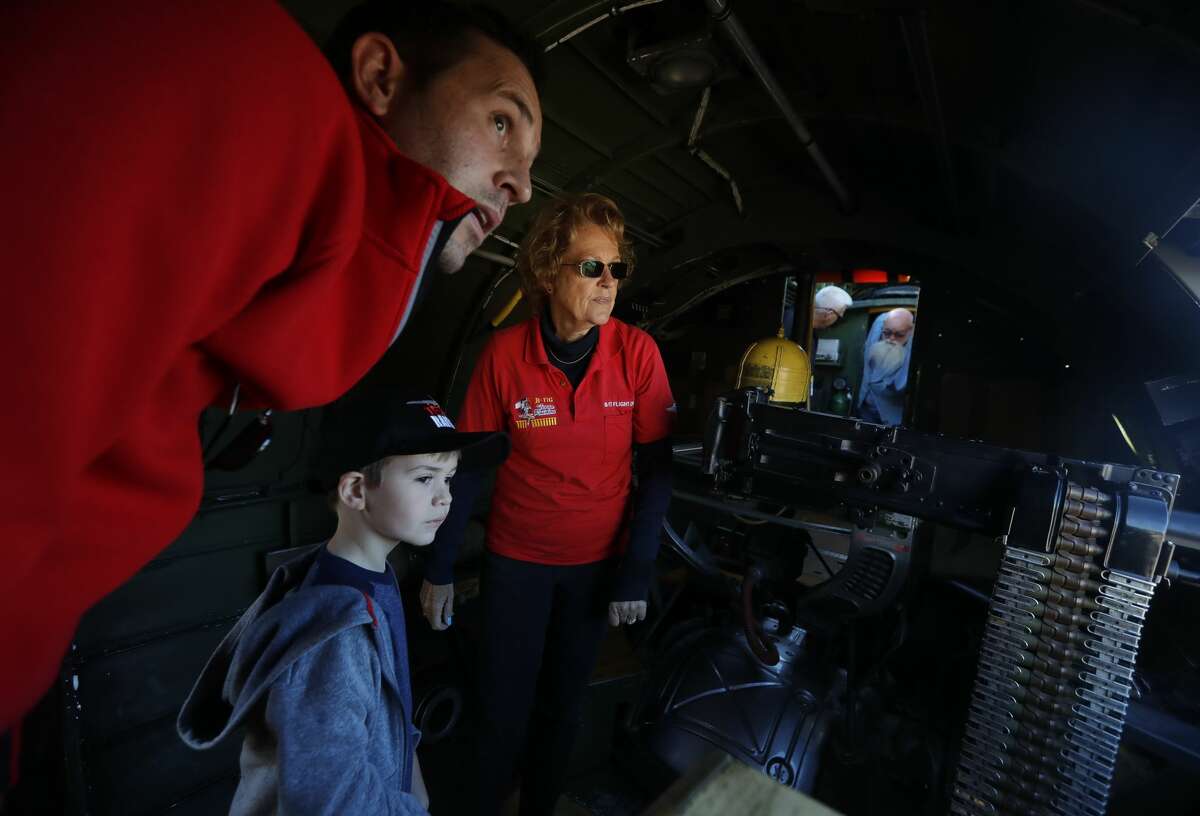 Peter Hochstaetter, left, takes his son, Pearson, to visit a B-17 flying fortress on a trip to General Aviation Services, Saturday, November 6, 2021, in Conroe. Guests were able to visit and pay for rides on three planes from the local base, including one