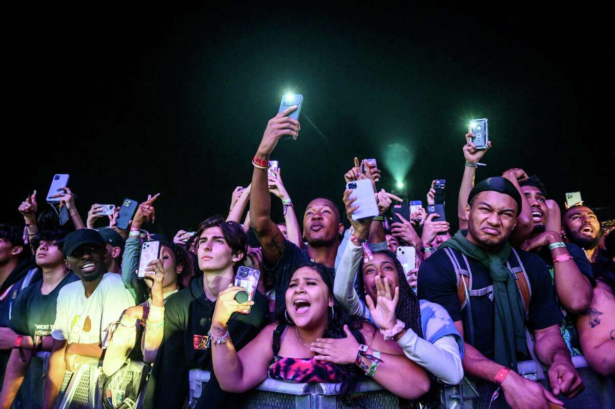 The crowd watches as Travis Scott performs at Astroworld Festival at NRG park on Friday, Nov. 5, 2021 in Houston. Several people died and numerous others were injured in what officials described as a surge of the crowd at the music festival while Scott was performing. Officials declared a “mass casualty incident” just after 9 p.m. Friday during the festival where an estimated 50,000 people were in attendance, Houston Fire Chief Samuel Peña told reporters at a news conference. (Jamaal Ellis/Houston Chronicle via AP)