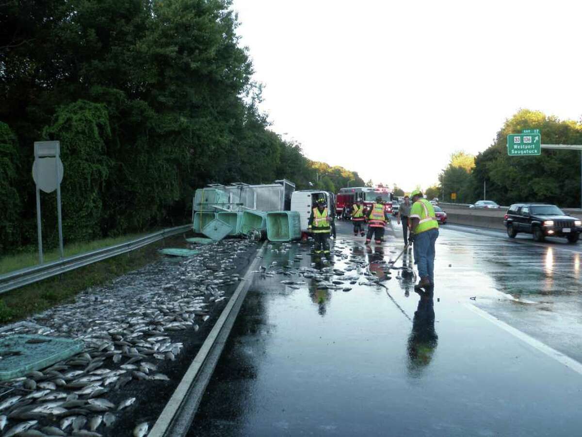 Emergency crews clean 2,500 pounds of live fish from Interstate 95 on Monday, Sept. 20, 2010, following a rollover that closed two lanes of traffic on the southbound side for nearly four hours. The driver was uninjured in the accident, but the load of fish was condemned by the Connecticut Department of Consumer Protection.