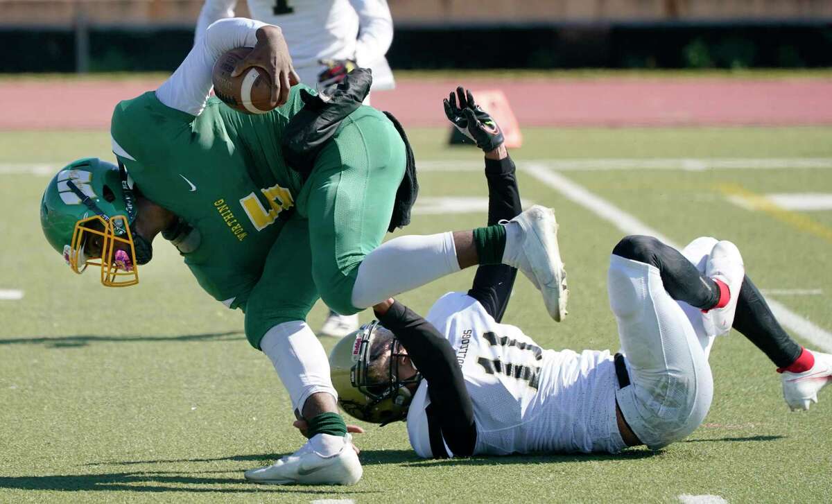 Worthing (5) Davion Edwards is brought down North Forest (11) Kobe Wright during the first quarter of District 11-4A Division I high school football game at Butler Stadium Saturday, Nov. 6, 2021 in Houston.