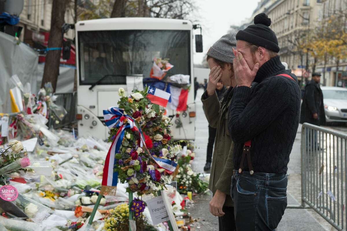 Eagles of Death Metal frontman Jesse Hughes (R) and drummer Julian Dorio visit a memorial that pays homage to the victims of the terrorist attacks at Le Bataclan on December 8, 2015 in Paris, France. The Eagles of Death Metal band returned to the Bataclan concert hall for the first time since the deadly terrorist attacks on November 13th where 130 people lost their lives and many more were injured. 