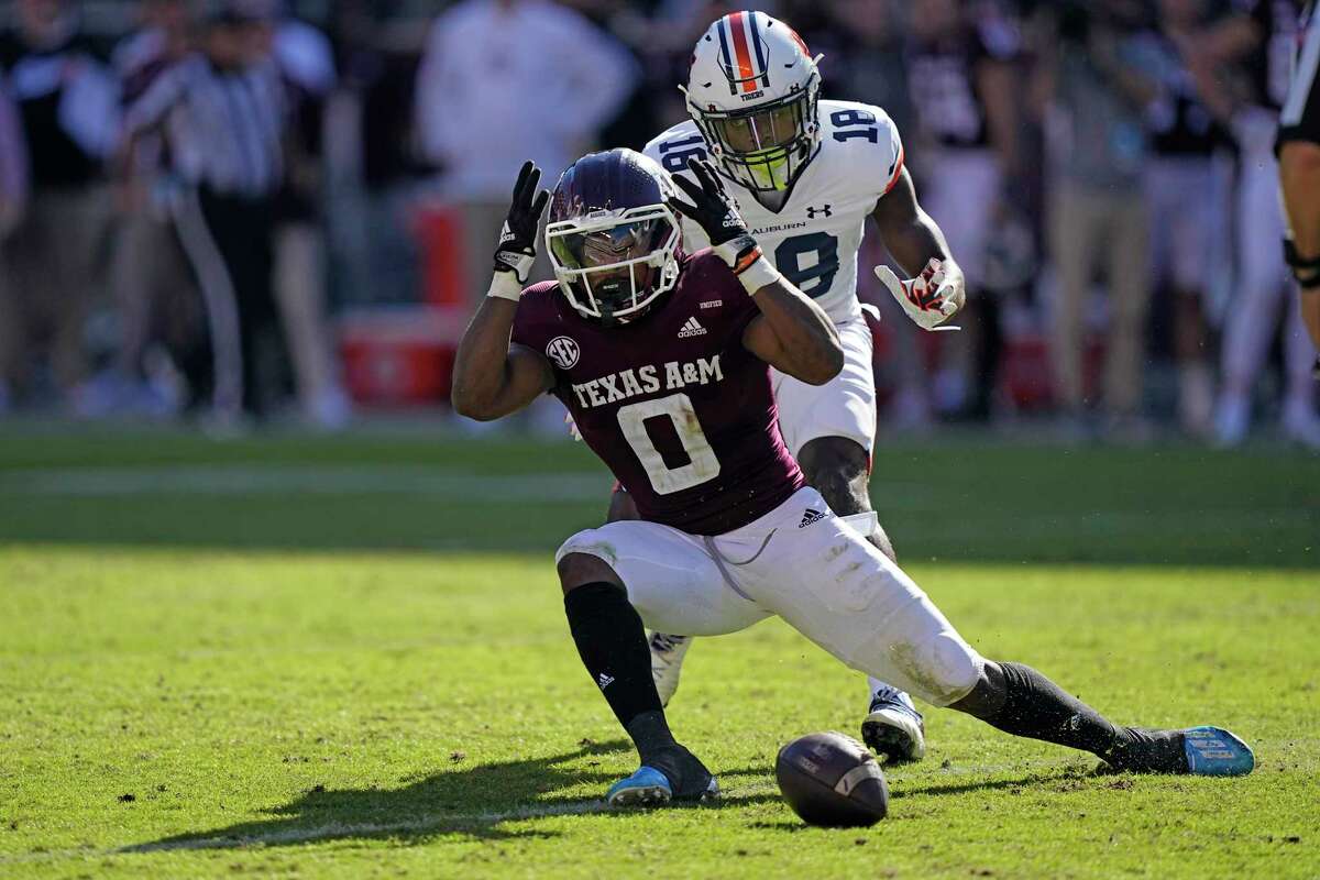 Texas A&M wide receiver Ainias Smith (0) drops a pass as Auburn cornerback Nehemiah Pritchett (18) defends during the first half of an NCAA college football game Saturday, Nov. 6, 2021, in College Station, Texas. (AP Photo/David J. Phillip)