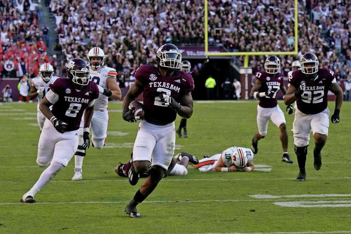 Texas A&M defensive lineman Micheal Clemons (2) returns a fumble by Auburn quarterback Bo Nix (10) for a touchdown during the second half of an NCAA college football game Saturday, Nov. 6, 2021, in College Station, Texas. Texas A&M won 20-3. (AP Photo/David J. Phillip)