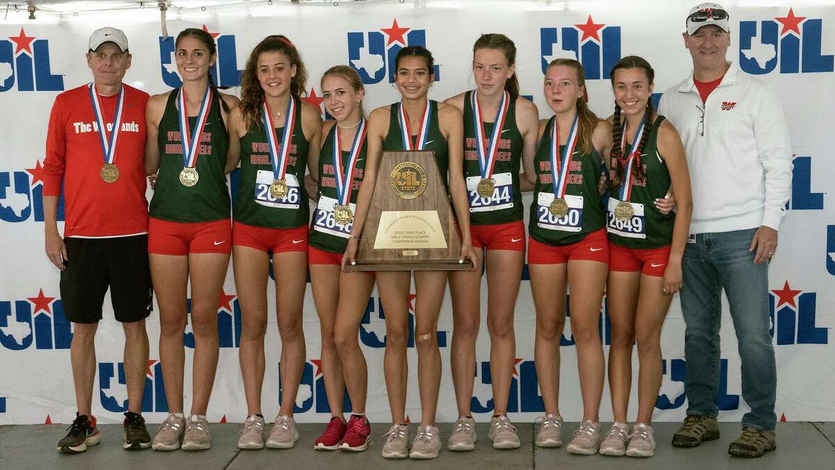 The Woodland girls team pose with medals and third place trophy during the 2021 UIL 6A Cross Country State Championship, Saturday, Nov., 6, 2021, in Round Rock, Texas.