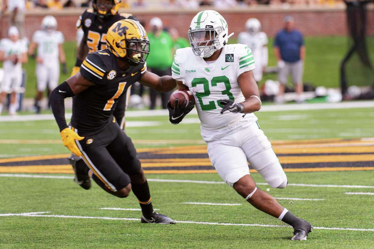 North Texas running back Isaiah Johnson, right, runs past Missouri's Jaylon Carlies, left, during the third quarter of an NCAA college football game Saturday, Oct. 9, 2021, in Columbia, Mo. (AP Photo/L.G. Patterson)