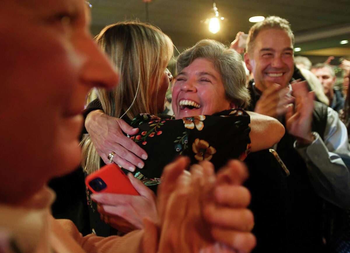 Newly-elected Republican Second Selectwoman Andrea Moore, left and First Selectwoman Jen Tooker hug and celebrate their victory with supporters at a Republican election returns party at Rizzuto's Oyster Bar and Restaurant in Westport, Conn. on Tuesday, November 2, 2021.