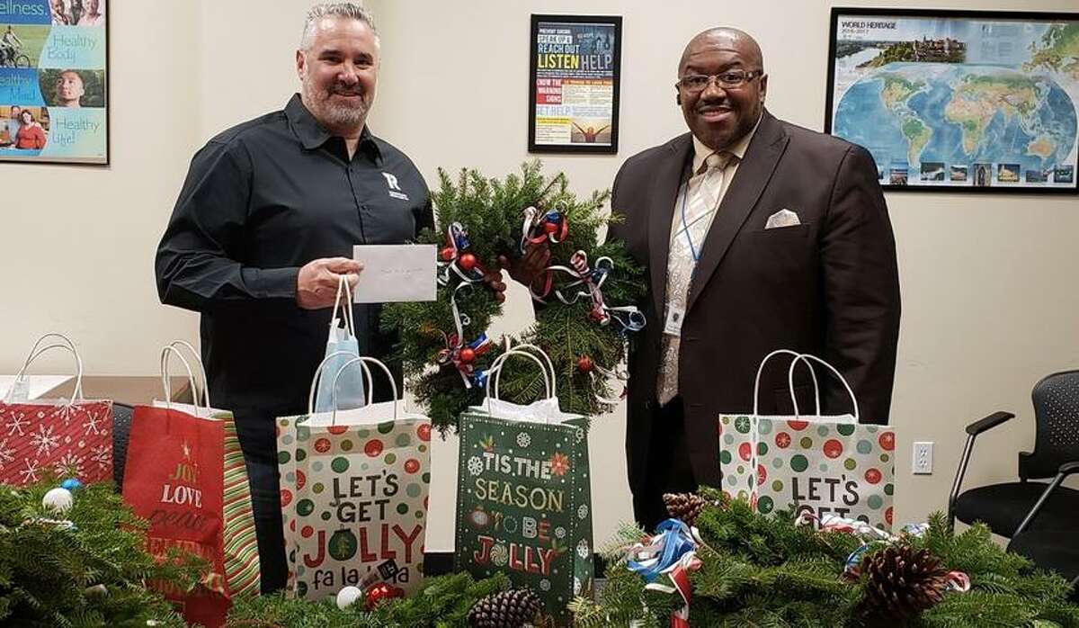 Frank Zabski, left, founder of “Operation St. Nicholas,” which brightens Christmas for needy veterans, prepares for the season with Carl Reynolds, employment and benefits manager at Columbus House by his side. Reynolds connects many veterans with the program.