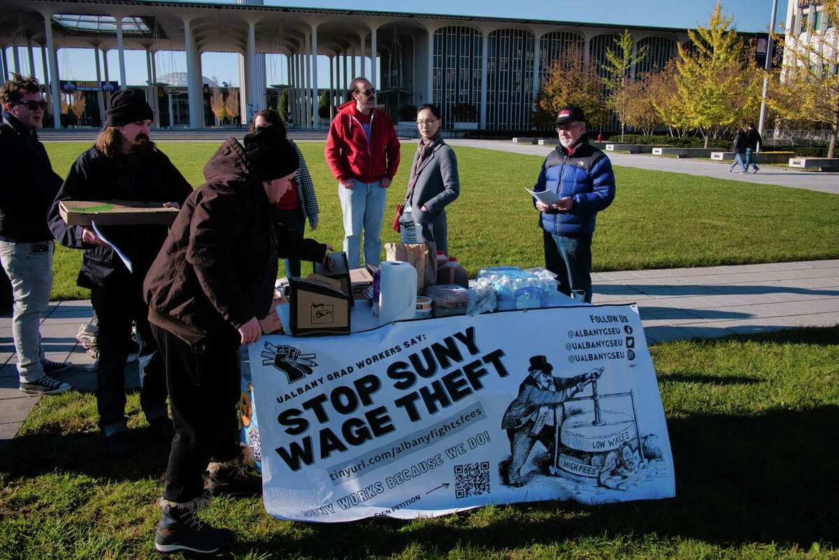 UAlbany teaching assistants hold a protest on the campus during the fall preview day for prospective students and their parents on Sunday, Nov. 7, 2021, in Albany, N.Y. The graduate students say that the university is taking money out of their pay as student fees.