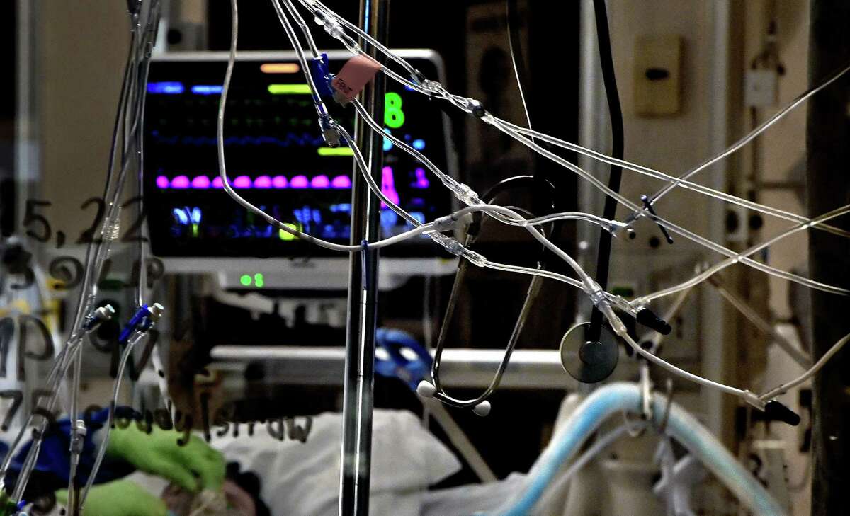 Tubes are attached to pumps that regulate the flow of medicine to a critically ill covid-19 patient at the Stillwater Medical Center in Stillwater, Okla., on Sept. 18.