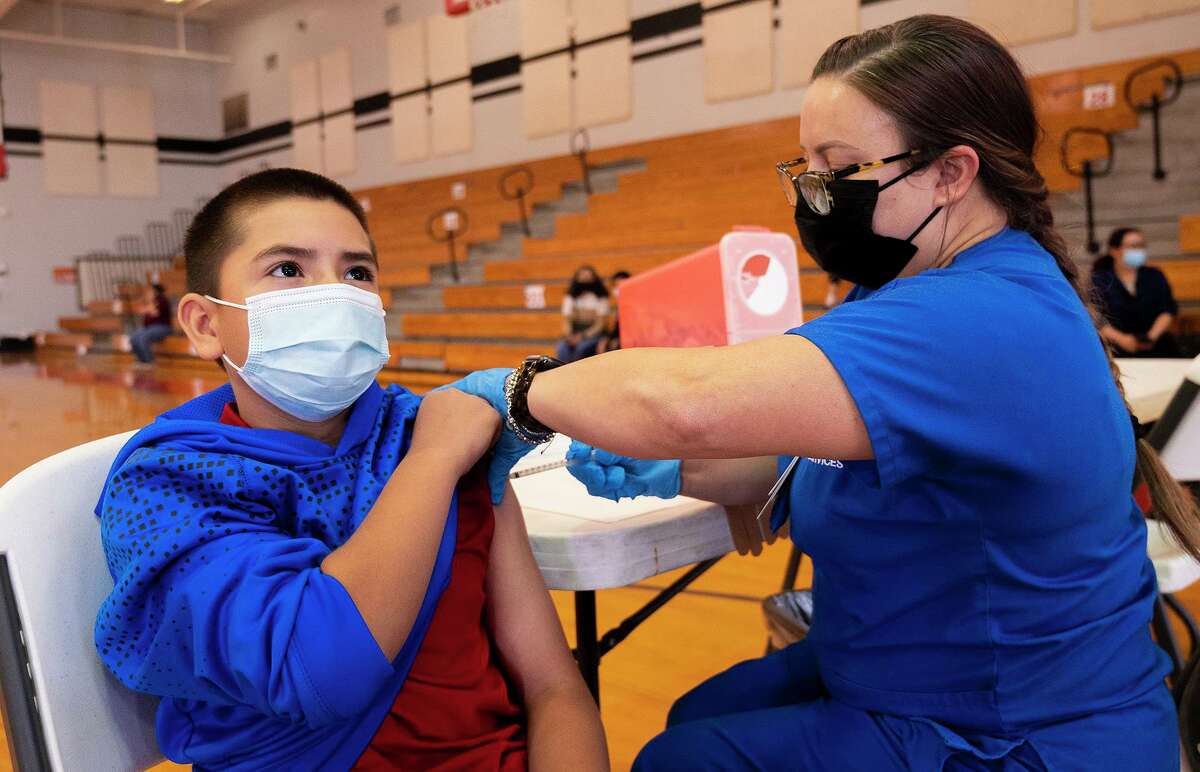 Memorial Middle School student Diego Martinez, 11, gets his COVID-19 vaccine from LISD RN Lori Skyles, Friday, Nov. 5, 2021 at Memorial Middle School.