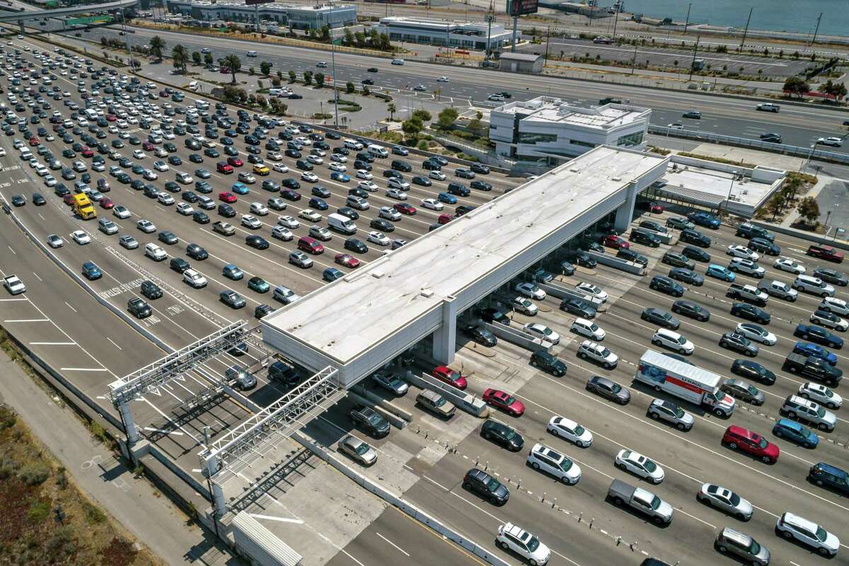 Traffic backs up at the tollbooths at the Bay Bridge in Oakland in July. Transportation contributes the most to the state’s output of greenhouse gases.