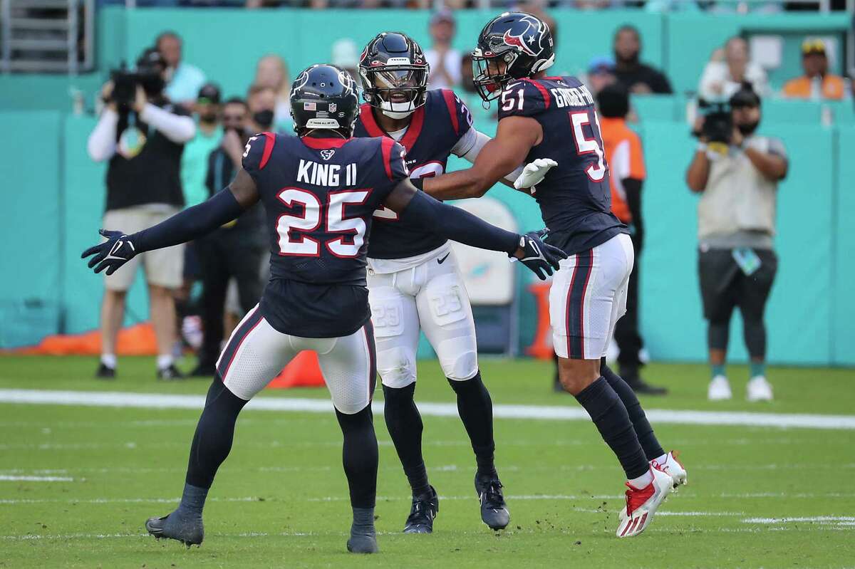 Houston Texans safety Eric Murray (23) celebrates with cornerback Desmond King II (25) and linebacker Kamu Grugier-Hill (51) after intercepting a pass by Miami Dolphins quarterback Jacoby Brissett during the first half of an NFL football game Sunday, Nov. 7, 2021, in Miami Gardens, Fla.