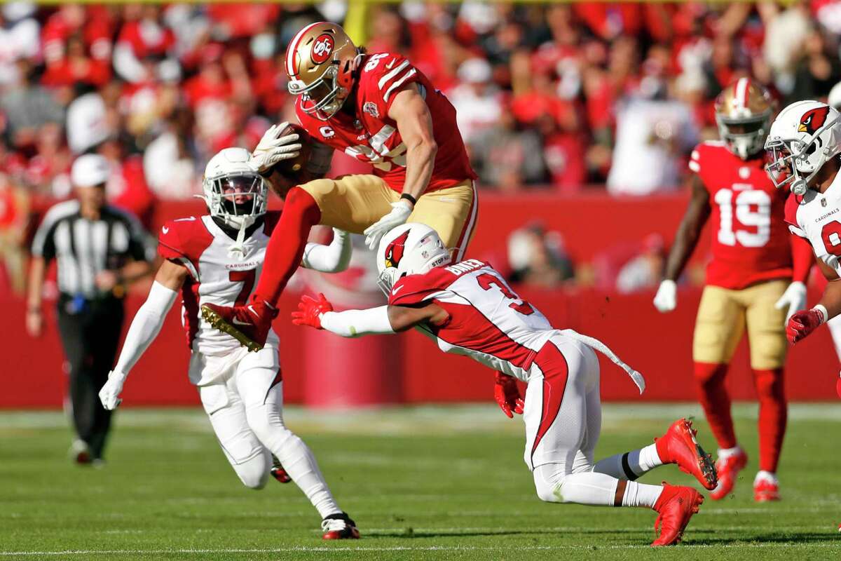 San Francisco 49ers tight end George Kittle hurdles Arizona safety Budda Baker before fumbling in the first quarter of Sunday’s game at Levi’s Stadium.