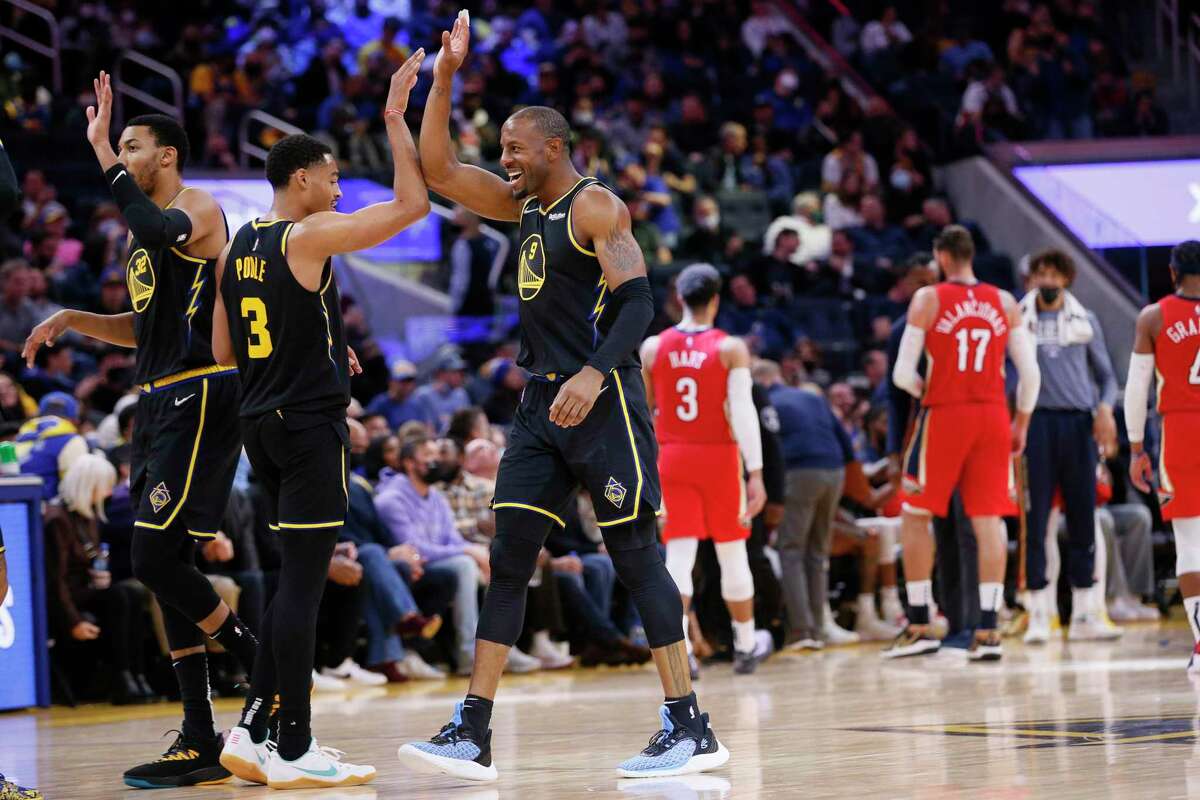 Golden State Warriors forward Andre Iguodala (9) high fives teammates during a timeout in the fourth quarter of an NBA game against the New Orleans Pelicans at Chase Center, Friday, Nov. 5, 2021, in San Francisco, Calif. The Warriors won 126-85.
