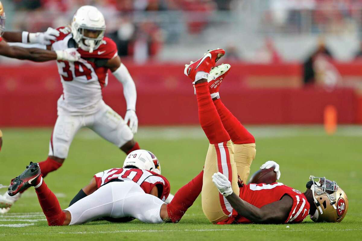 San Francisco 49ers' Deebo Samuel ends up on his back after being tackled by Arizona Cardinals' Marco Wilson in 4th quarter during Cardinals' 31-17 win in NFL game at Levi's Stadium in Santa Clara, Calif., on Sunday, November 7, 2021.