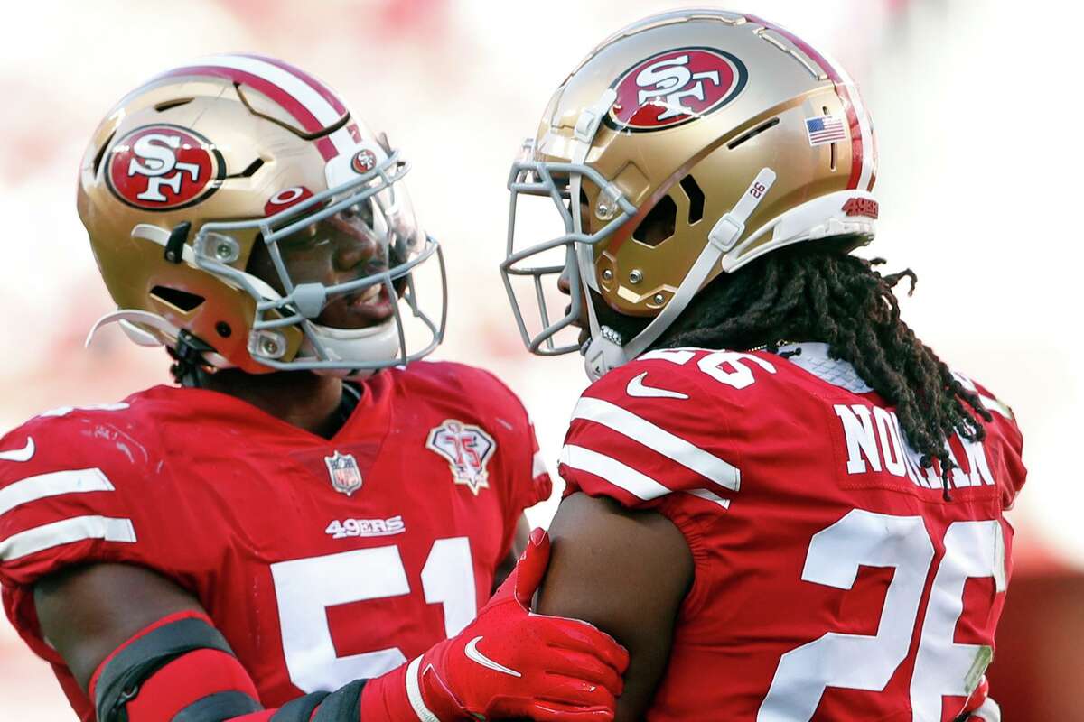 San Francisco 49ers linebacker Azeez Al-Shaair talks to teammate Josh Norman after Norman’s penalty in the second quarter of Sunday’s game against the Arizona Cardinals.