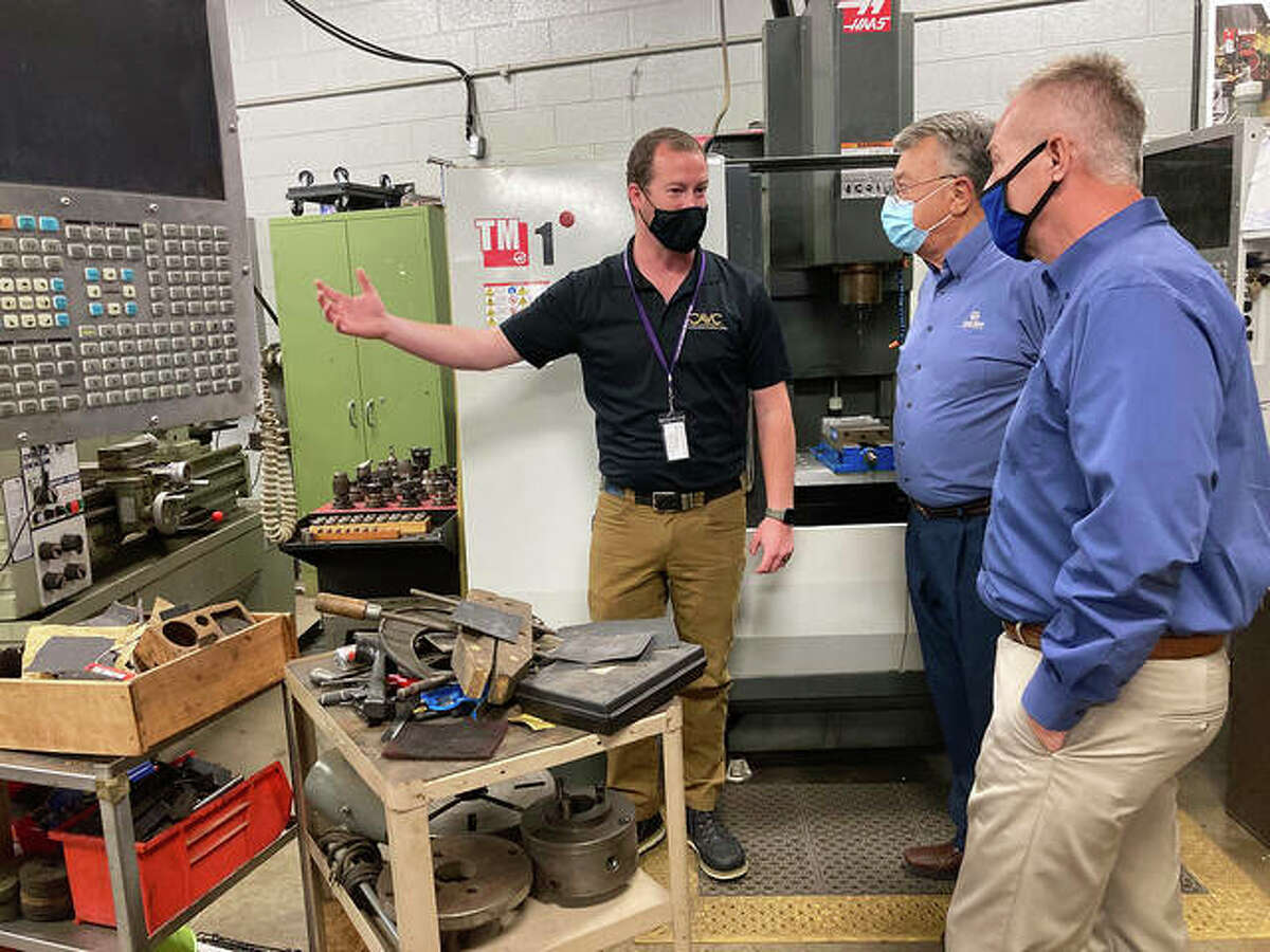 CAVC Director Joe McGinnis, center, gives a tour of the CAVC Precision Machining shop to Jim McKay and Earl Flack.