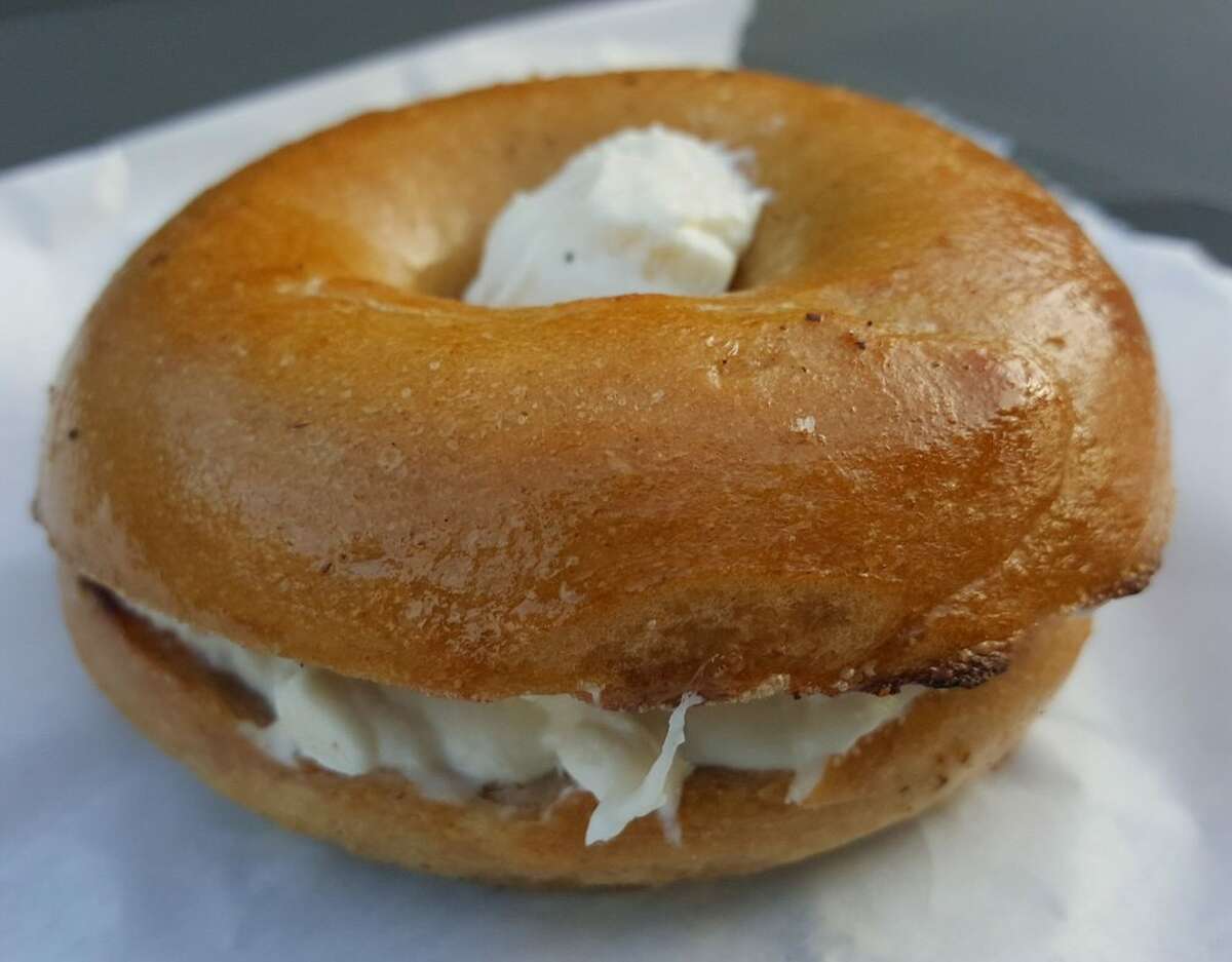 Toasted plain bagel with roasted garlic cream cheese from Zylberschtein’s.