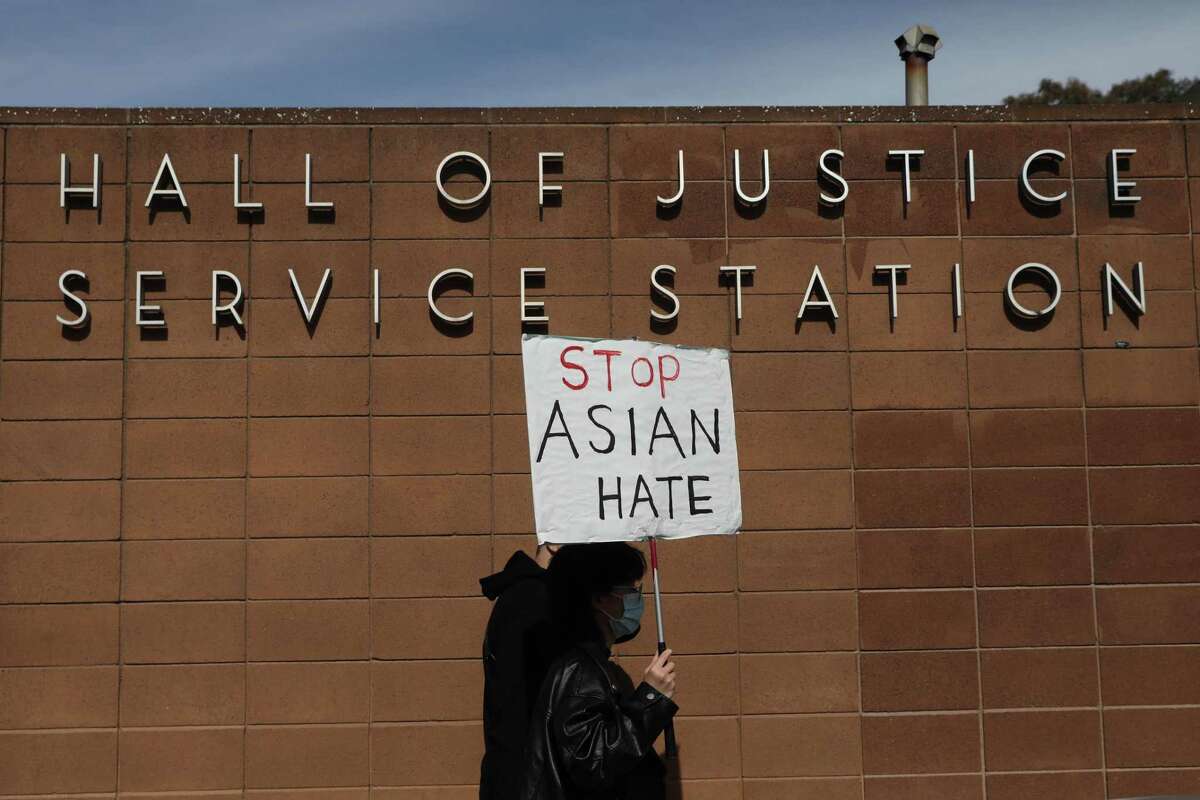 Elaine Qi marches against anti-Asian hate during a March rally in San Francisco for Vicha Ratanapakdee, who died after being pushed to the pavement as he walked through his neighborhood in the city.