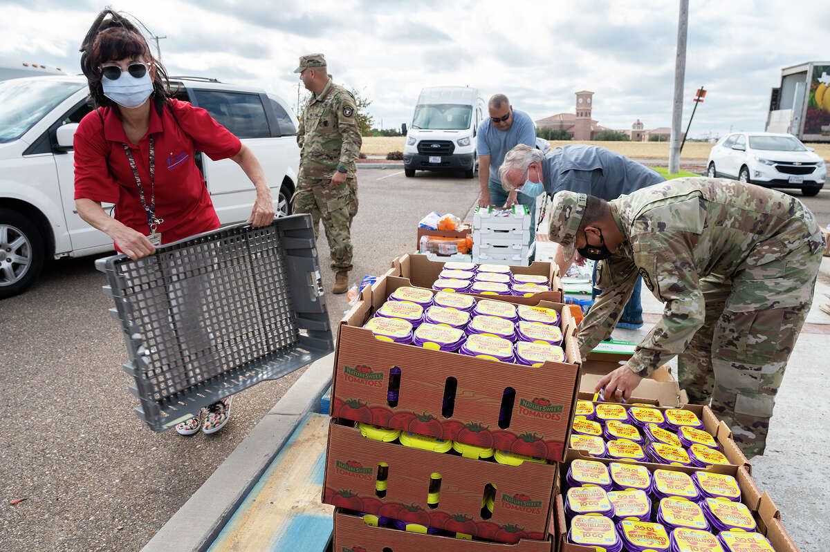 Member of the Texas National Guard and Department of Veteran Affairs Voluntary Service in Corpus Chrisit help distribute foods to veterans, Monday, Nov. 8, 2021 at the Laredo VA Outpatient Clinic during a free drive-thru food pantry.