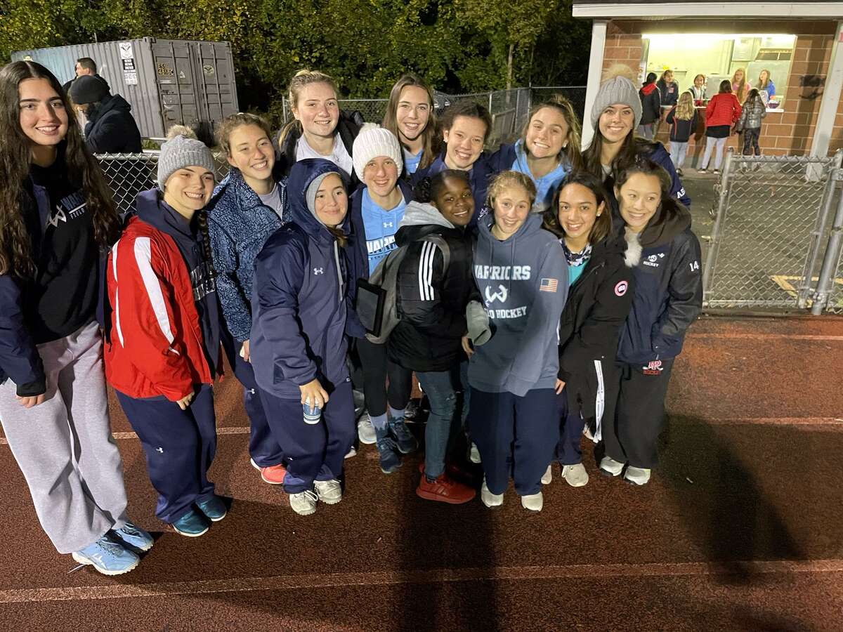 Wilton's Natasha Ring (center with white cap) recently received the FCIAC Field Hockey Coaches Courage award for her long journey back to the field after a paralyzing injury.