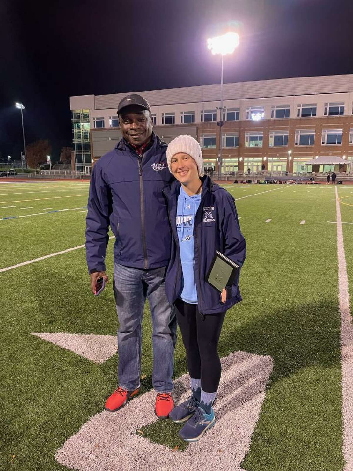 Wilton's Natasha Ring, with her coach Leon Kerr, recently received the FCIAC Field Hockey Coaches Courage award for her long journey back to the field after a paralyzing injury.