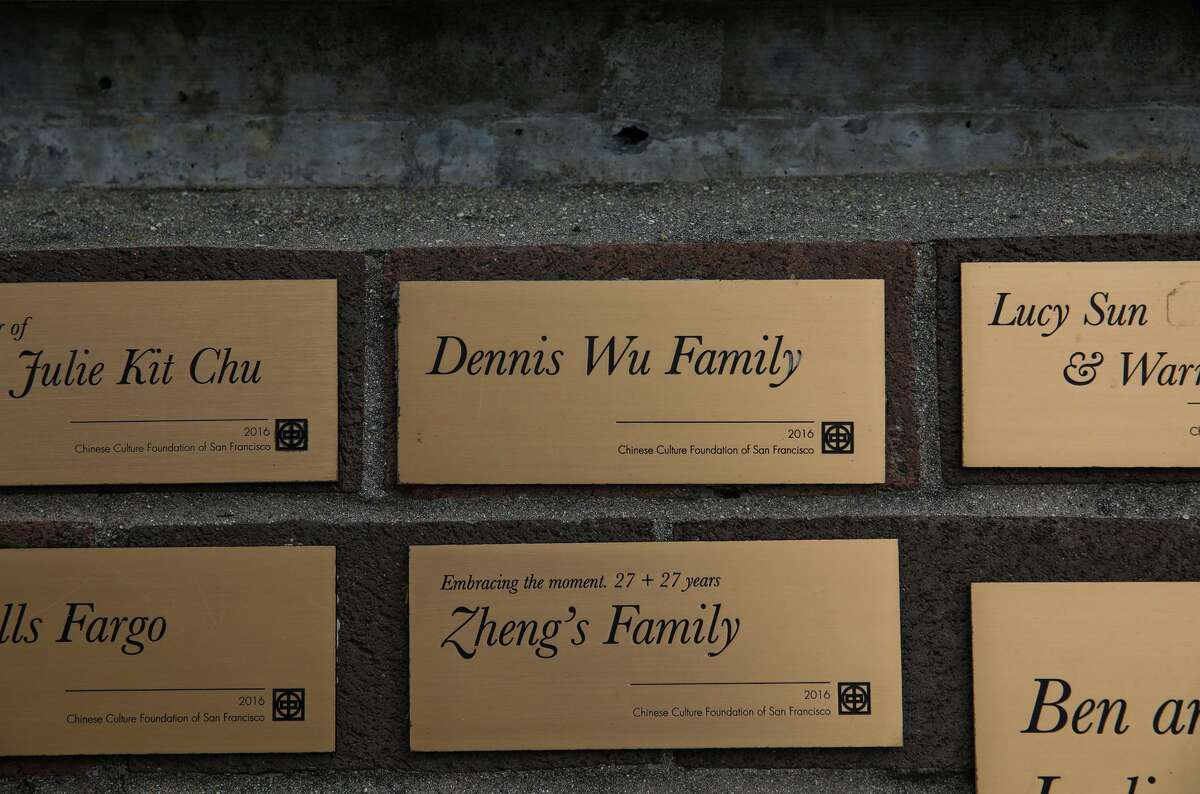 Dennis Casey Wu (not pictured) takes a photo of a donation wall plaque displaying his family's name at the Chinese Cultural Center at Portsmouth Square on Friday, Nov. 5, 2021, in San Francisco, Calif.