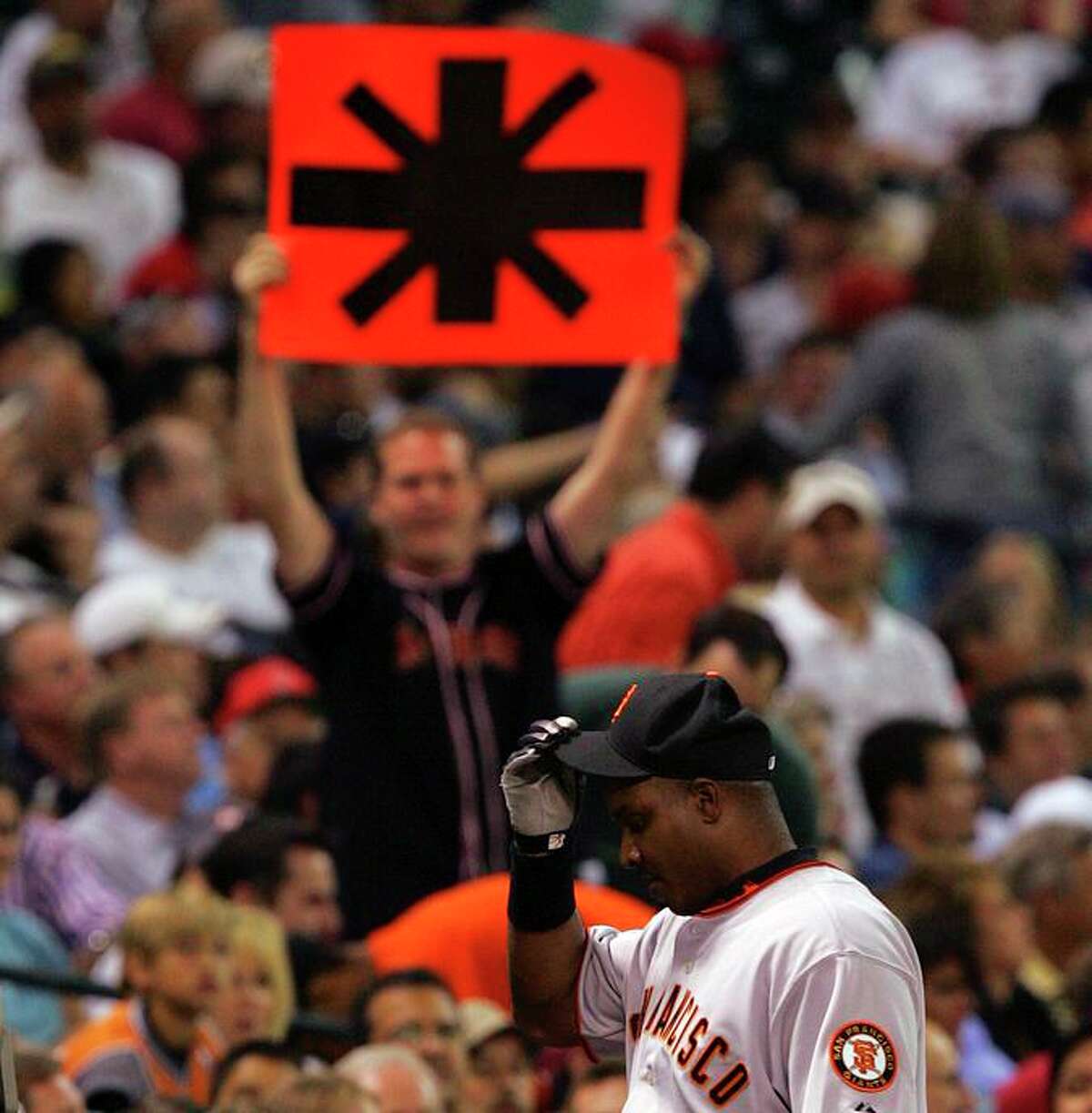SPORTS - A man holds an asterik sign as Barry Bonds walks off the field Monday May 15, 2006 at Minute Maid Park. Bonds failed to homer in the game, staying one behind Babe Ruth for second place all time. BAHRAM MARK SOBHANI/STAFF