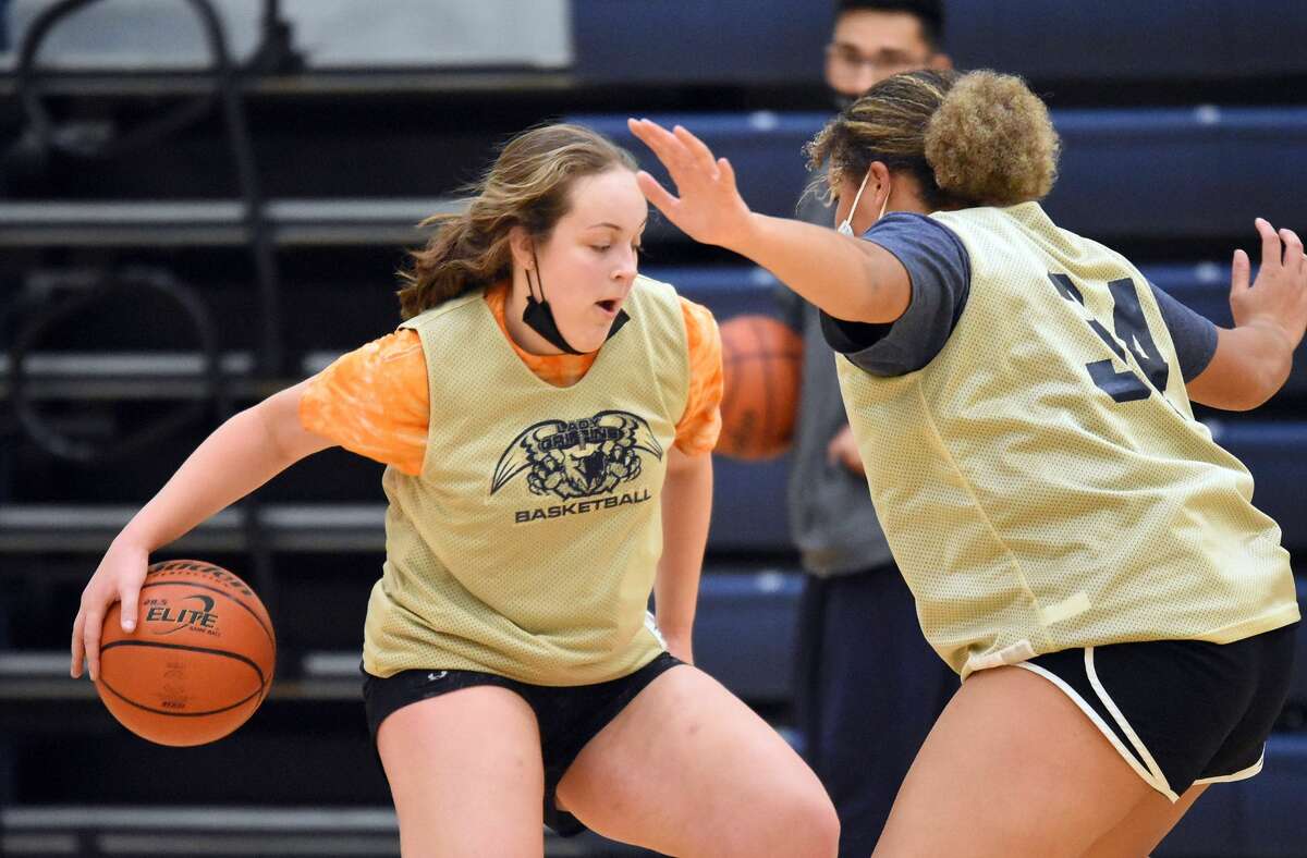 Father McGivney's Charlize Luehmann, left, runs through a drill during a practice for the Griffins.