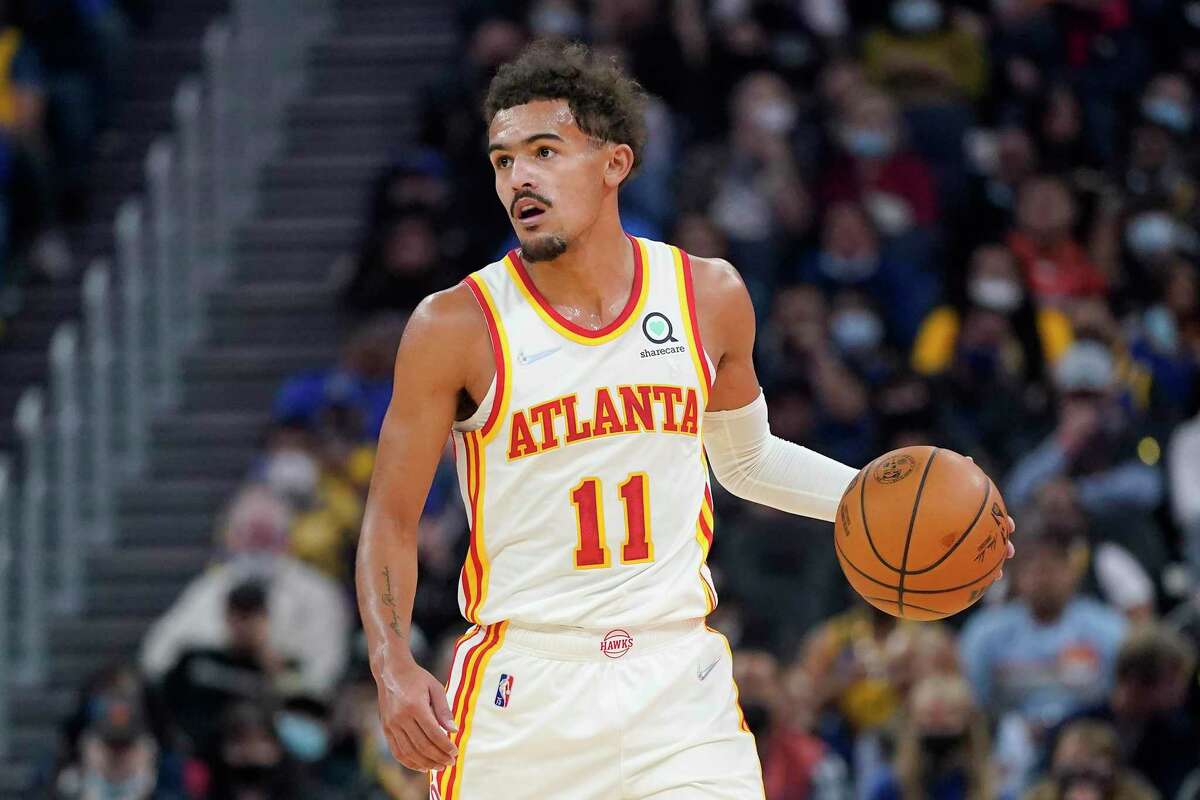 Atlanta Hawks guard Trae Young (11) dribbles up the court against the Golden State Warriors during the first half of an NBA basketball game in San Francisco, Monday, Nov. 8, 2021. (AP Photo/Jeff Chiu)