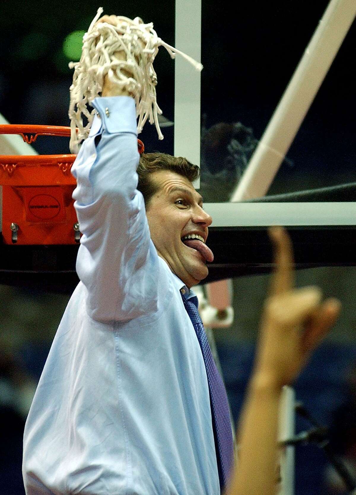 UConn coach Geno Auriemma celebrates after cutting down the net after UConn won the National Championship at the Alamodome in San Antonio on Sunday, Mar. 31, 2002. (Kin Man Hui/staff)