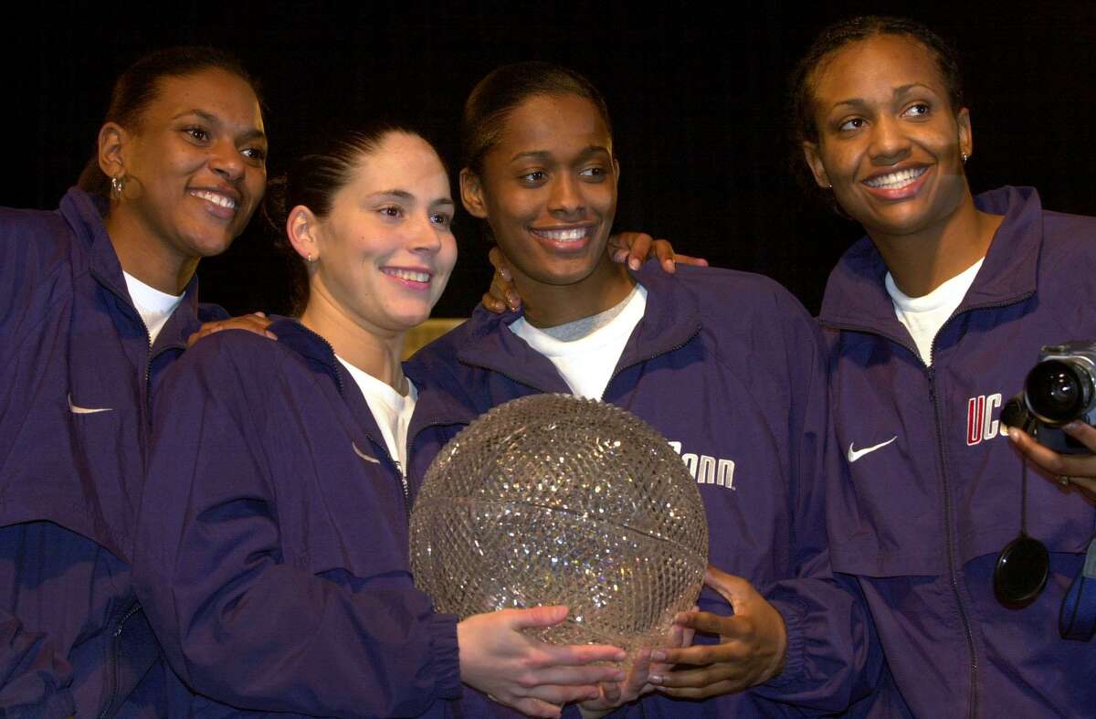 FOR SPORTS DAILY - Members of the UConn team Asjha Jones(from left) Sue Bird, Swin Cash, and Tamika Williams hold the Sears Trophy at Sunset Station Sunday March 31, 2002 after defeating Oklahoma in the NCAA Women Final Four. PHOTO BY EDWARD A. ORNELAS