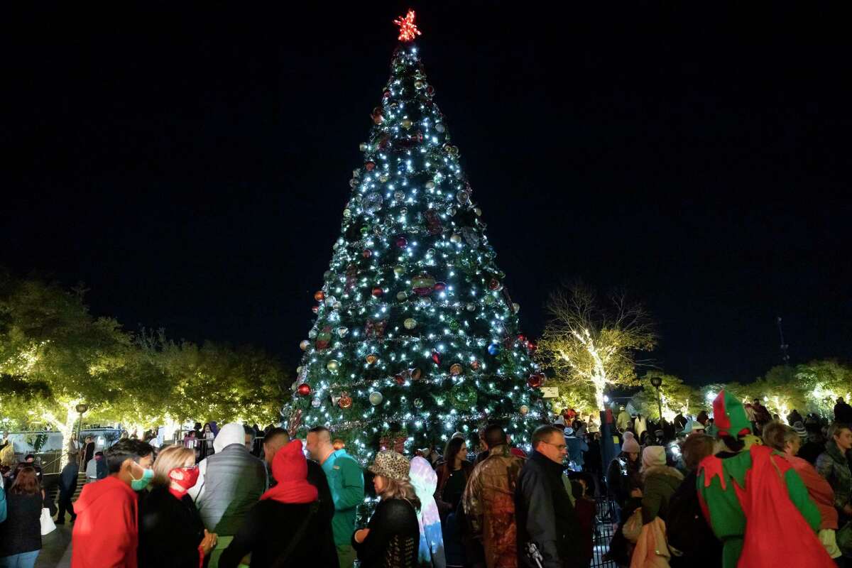 Spectators gather around a Christmas tree during the Conroe Christmas Tree Lighting event in Heritage Park, Tuesday, Dec. 1, 2020, in Conroe. Hundreds of people converged to partake in the festivities. This year’s tree lighting is set for Tuesday, Nov. 30, at 6 p.m.