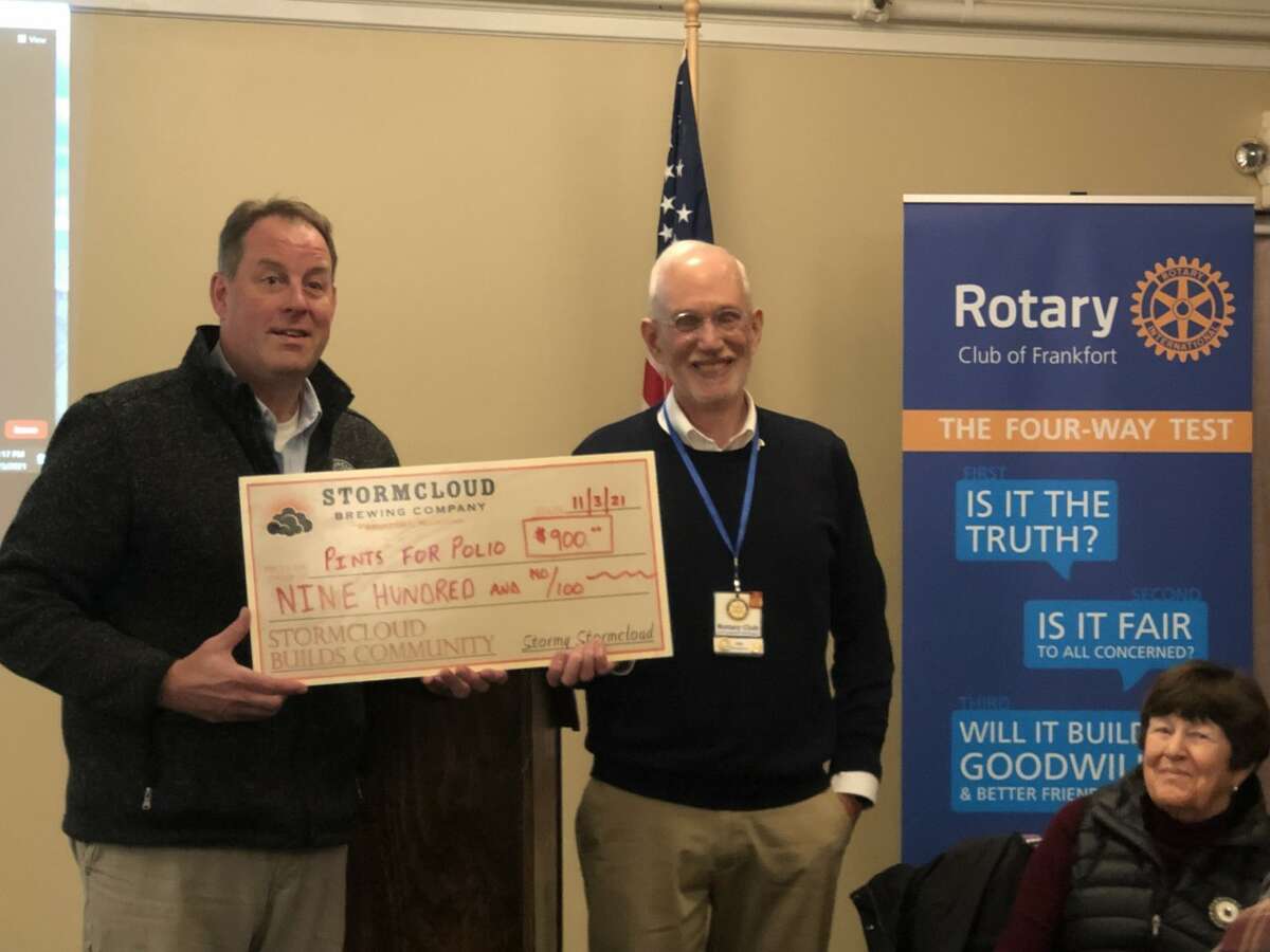Rick Schmitt, of Stormcloud Brewing Co., hands Frankfort Rotary President Jay Peregrine a check representing Stormcloud’s pledge of $1 per pint of beer sold at their Main Street location during this year’s Beer Week to benefit Rotary’s “Pints for Polio” drive.