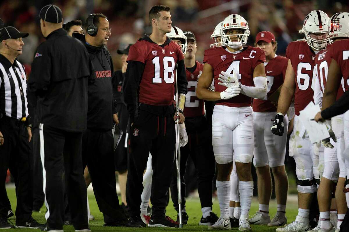 Injured Stanford quarterback Tanner McKee (18) stands with his teammates during the fourth quarter of an NCAA college football game against Utah, Friday, Nov. 5, 2021, in Stanford, Calif. (AP Photo/D. Ross Cameron)