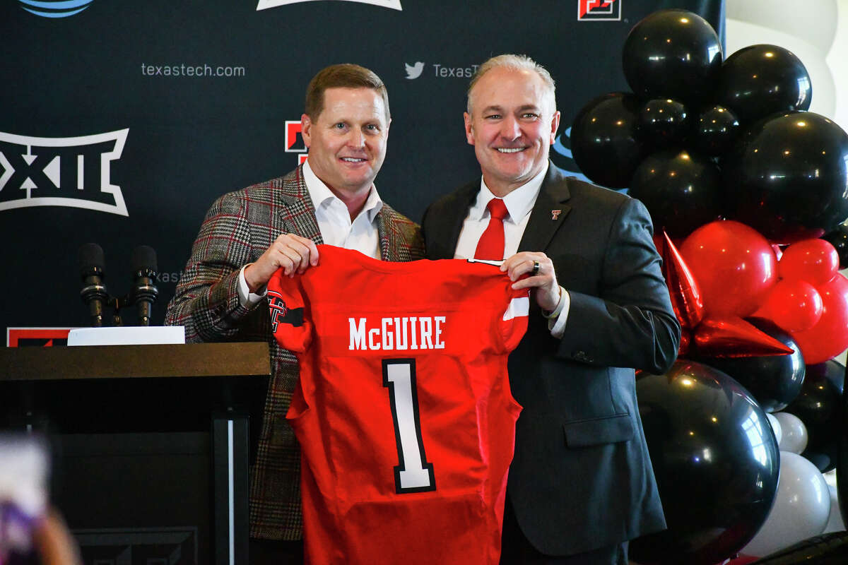 New Texas Tech head football coach Joey McGuire (right) and TTU athletic director Kirby Hocutt hold up a jersey at McGuire's introductory press conference on Tuesday in Jones AT&T Stadium. 