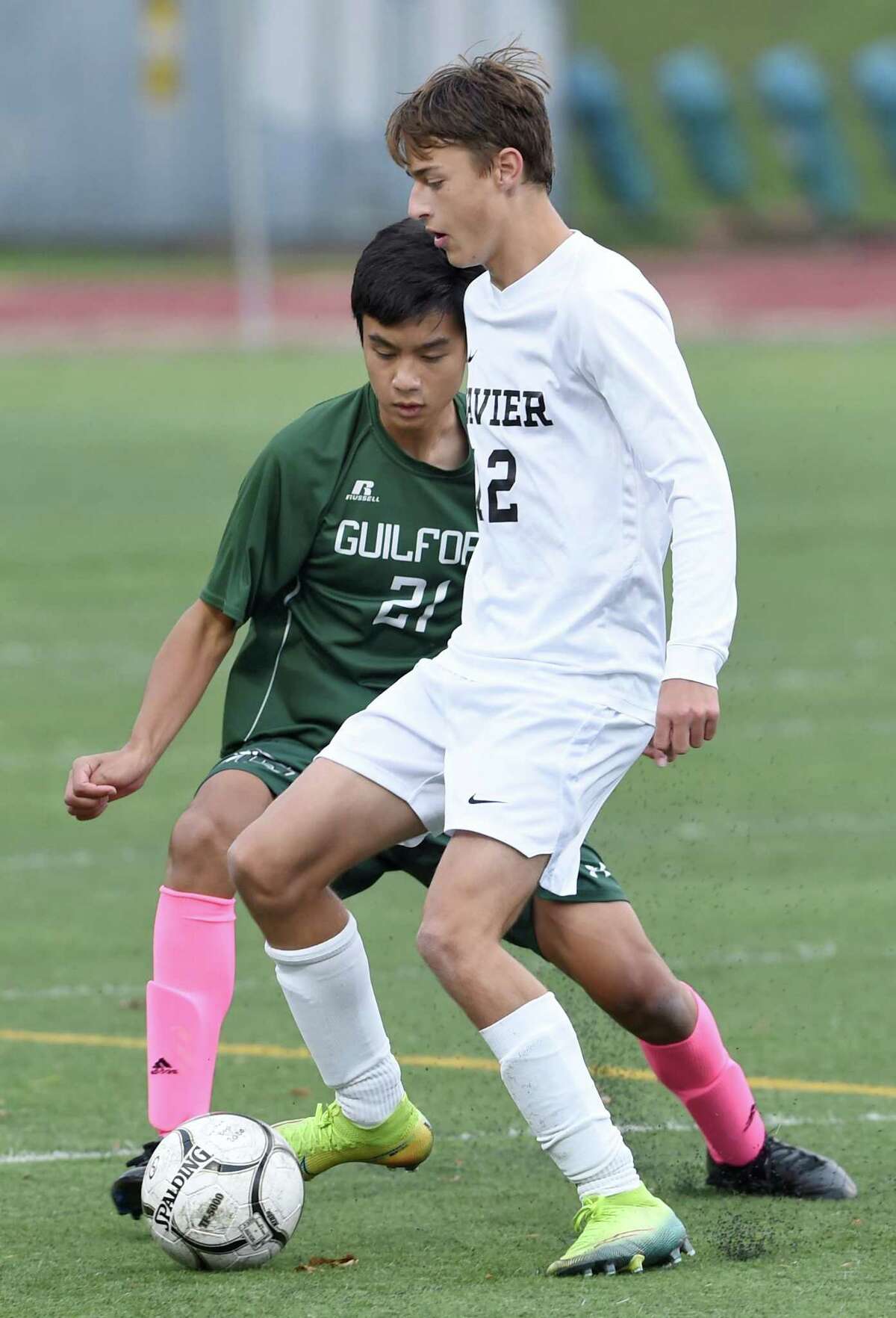 Joshua Chen of Guilford (left) and Ryan Gerry of Xavier fight for the ball in Guilford on October 27, 2020.
