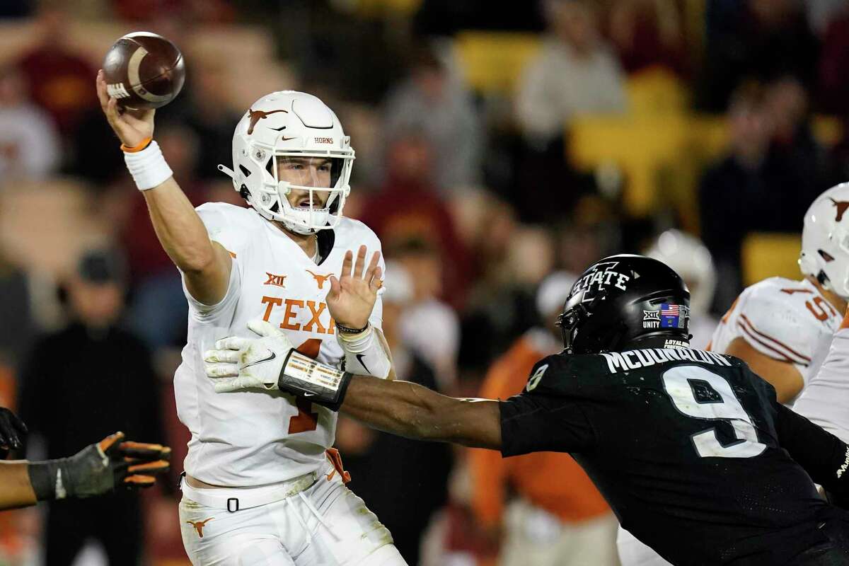 Texas quarterback Hudson Card (1) passes as he is pressured by Iowa State defensive end Will McDonald IV (9) during the second half of an NCAA college football game, Saturday, Nov. 6, 2021, in Ames, Iowa. Iowa State won 30-7. (AP Photo/Charlie Neibergall)