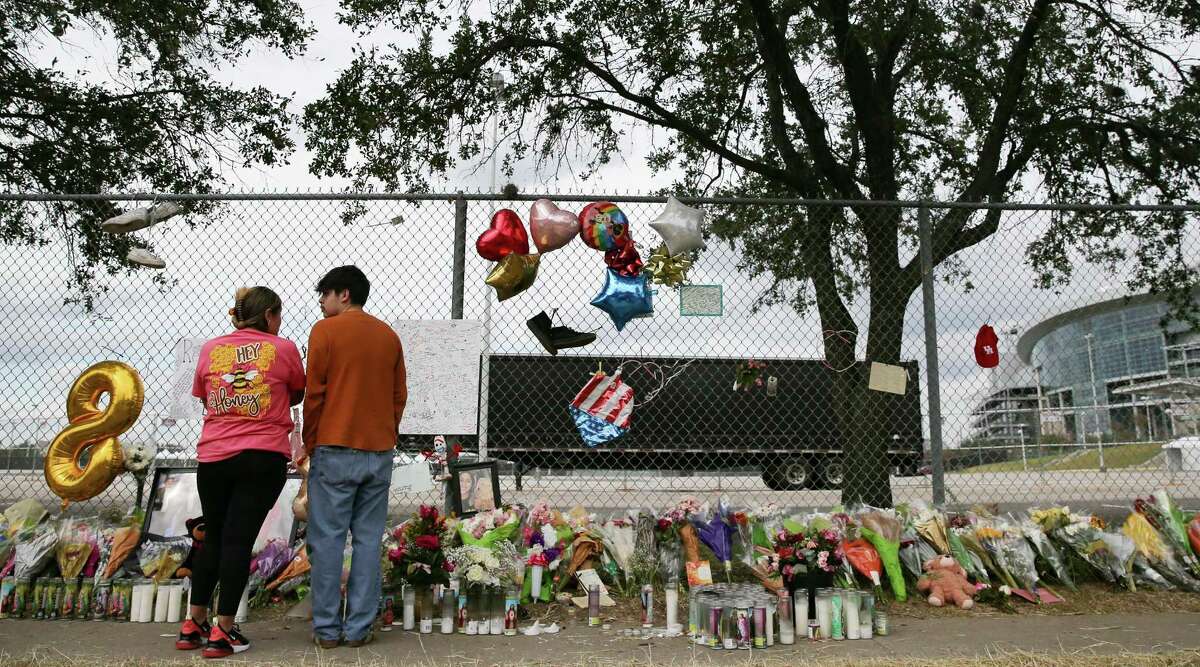 Daniela Morales of Katy and Robert Ortiz have a moment in front of the makeshift memorial at Westridge and Kirby, in honor of the victims of the deaths Friday night at Astroworld Festival on Tuesday, Nov. 9, 2021 in Houston. Morales didn’t know anyone who died when the crowd surged, but attended the festival. “This is my first time back here,” she said.