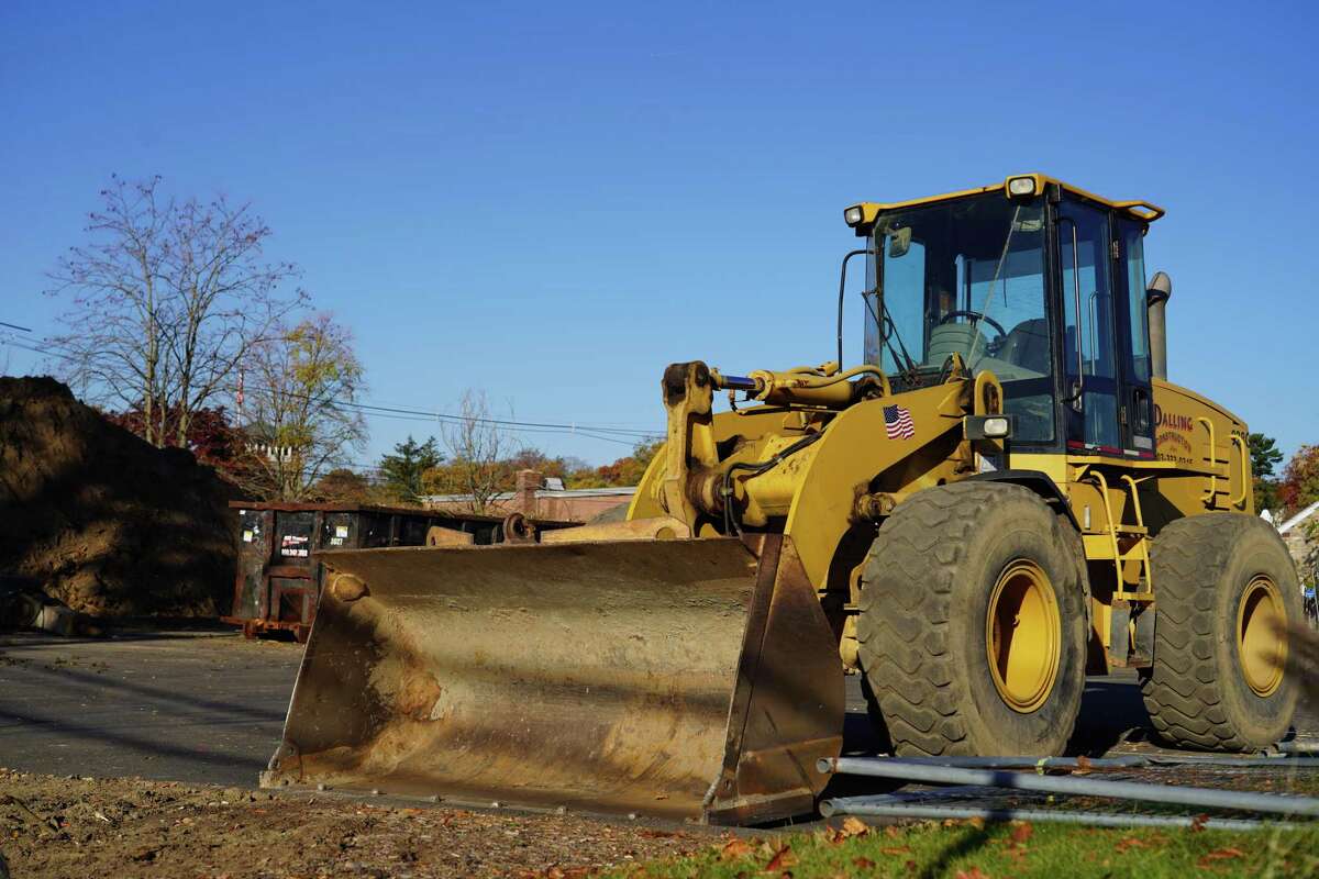 As ground is broken for the new New Canaan library, a large mound of dirt and earth movers can be seen at the site on Tuesday.