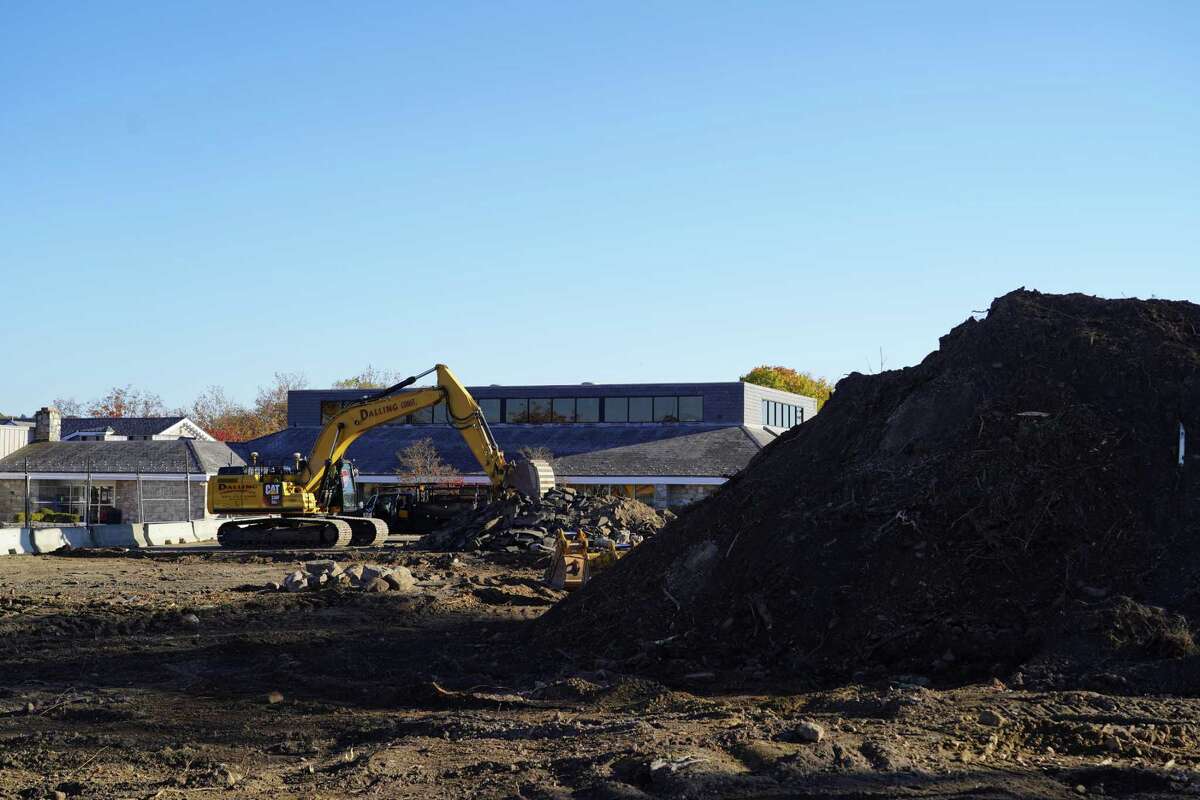 A large mound of dirt and earth movers can be seen on Tuesday, as ground is broken for the new New Canaan library building.