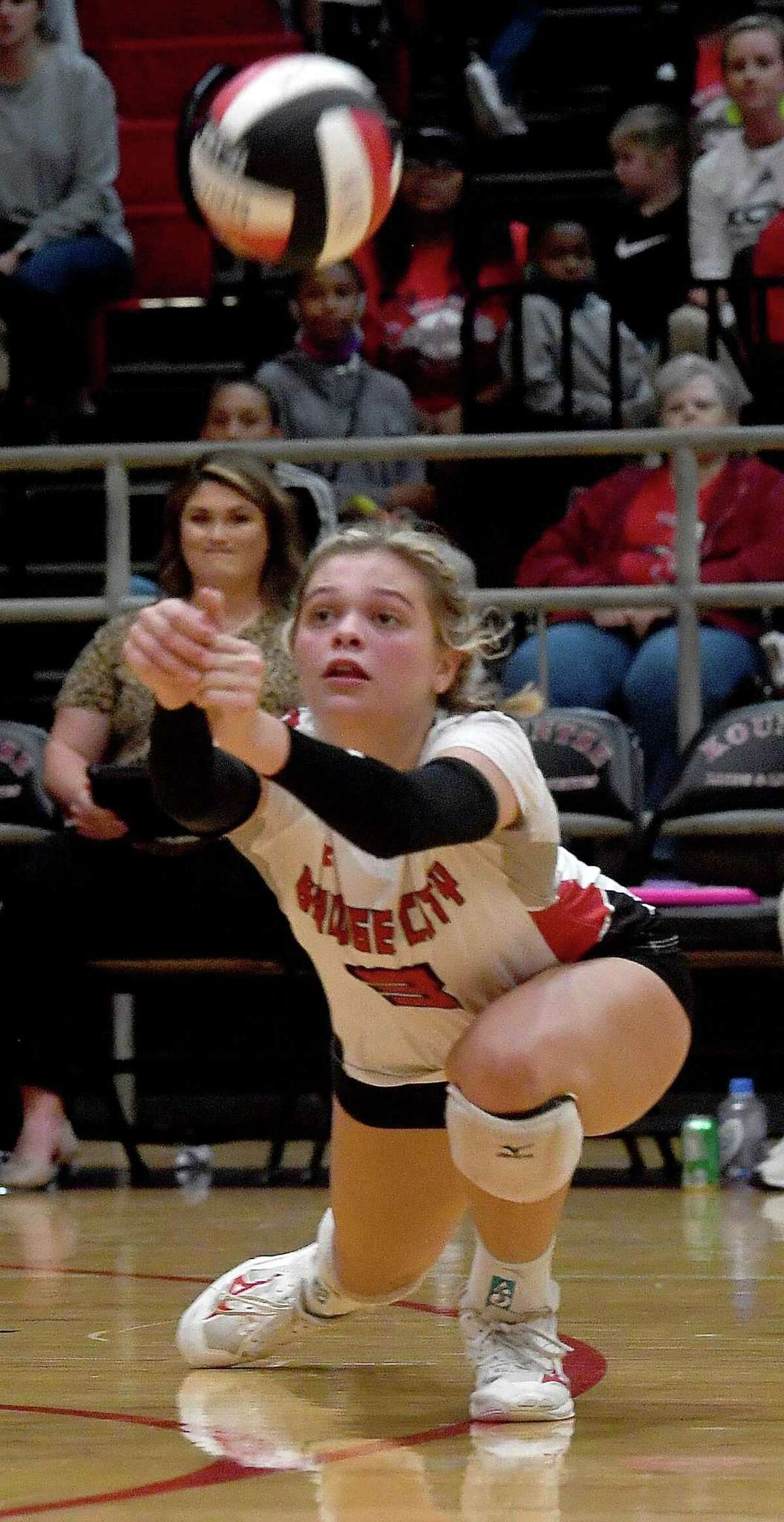 Bridge City's Harlee Tupper digs down to keep the ball alive as they battle Huffman-Hargrave during their regional quarterfinal playoff in Kountze. Photo made Tuesday, November 9, 2021 Kim Brent/The Enterprise