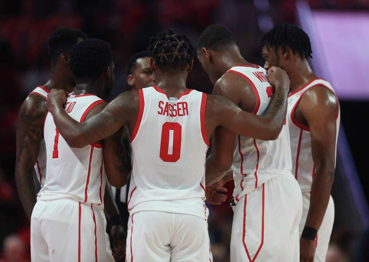 Houston Cougars guard Marcus Sasser (0) and teammates huddle during overtime of the game against the Hofstra Pride Tuesday, Nov. 9, 2021, at Fertitta Center in Houston. The Cougars defeated the Pride 83-75 in overtime.