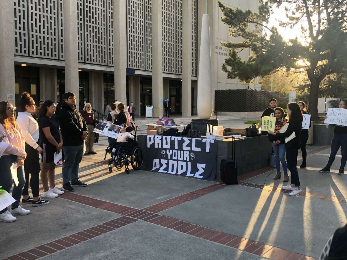 This file photograph shows immigration advocates protesting outside the San Mateo County Hall of Justice and Records ahead of a Truth Act Forum.