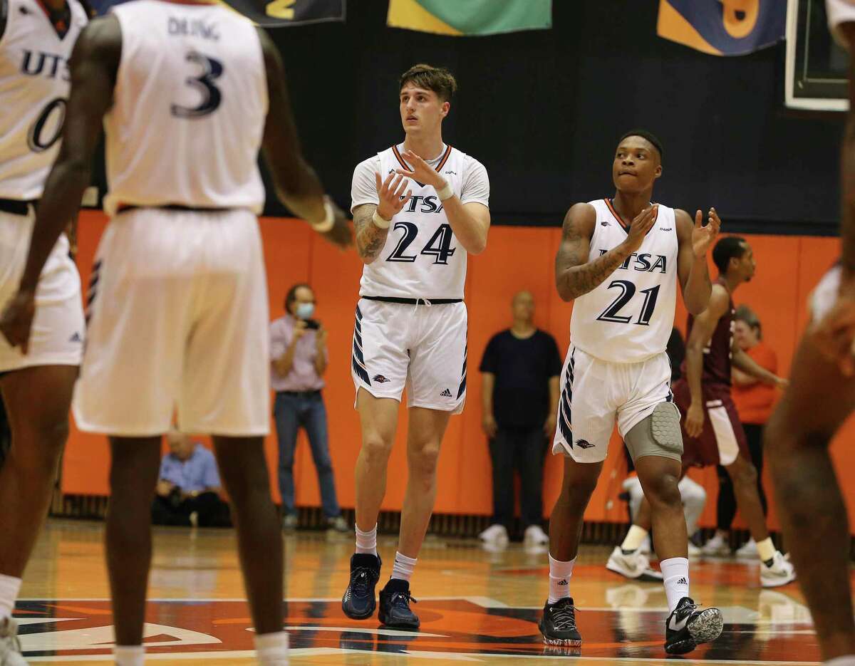 UTSA's Jacob Germany (24) and Jordan Ivy-Curry applaud the team's efforts against Trinity during men's basketball at the Convocation Center on Tuesday, Nov. 9, 2021.