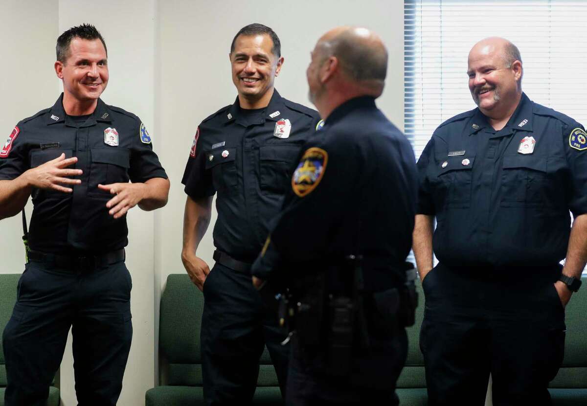 Montgomery County Sheriff Deputy Dax Byer, center, visits with The Woodlands firefighters Justin Bumpass, Rosendo Ortiz and John Fuller who responded to his heart attack during a save reunion at the Montgomery County Hospital District, Tuesday, Nov. 9, 2021, in Conroe.