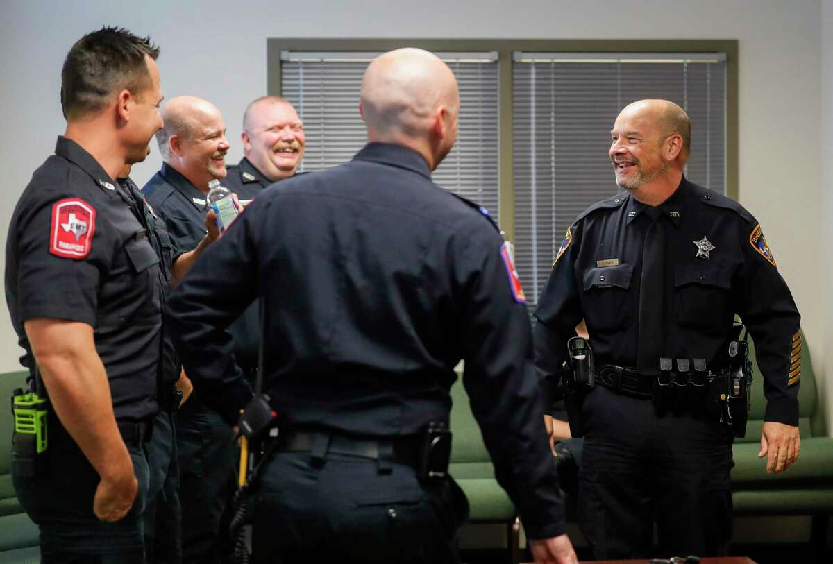 Montgomery County Sheriff Deputy Dax Byer, right, visits with paramedics and fire fighters who responded to his heart attack during a save reunion at the Montgomery County Hospital District, Tuesday, Nov. 9, 2021, in Conroe.